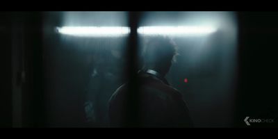 a blurry image of a man standing in a dark room