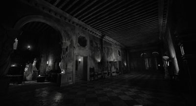 a black and white photo of a hallway in a building