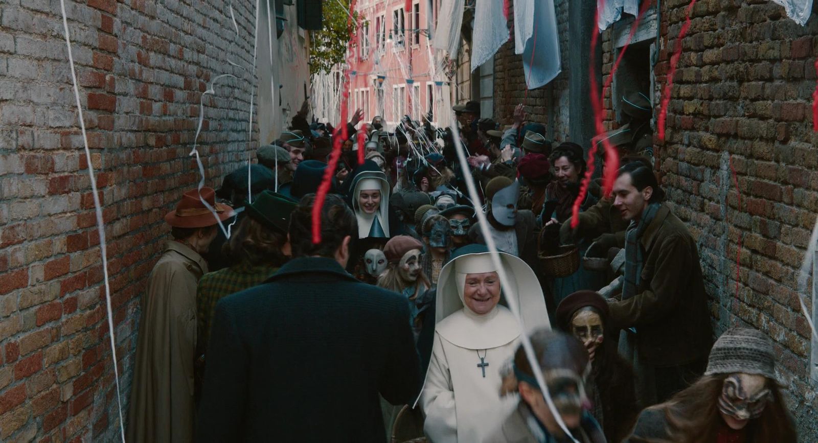 a group of people walking down a narrow street