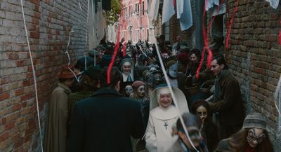 a group of people walking down a narrow street