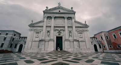 a large white building with a black and white checkered floor