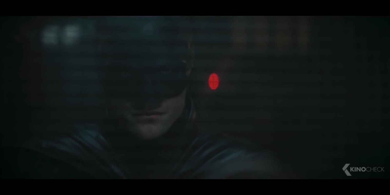 a man in a batman costume standing in the dark