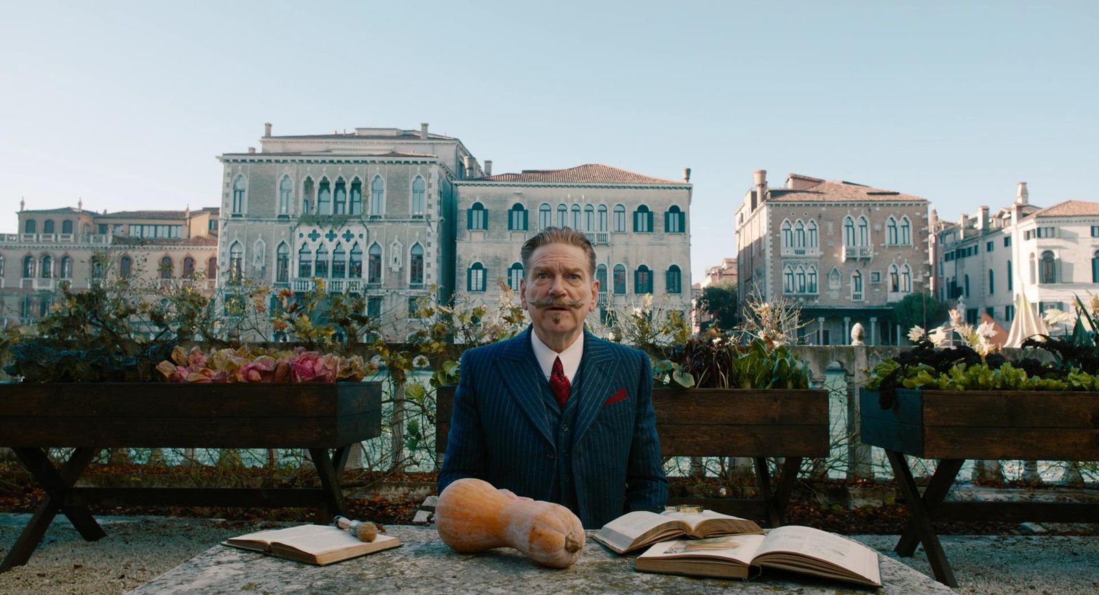 a man sitting on a bench next to a book