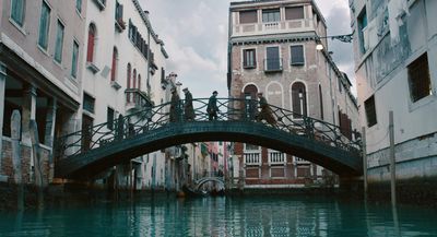 a bridge over a body of water next to tall buildings