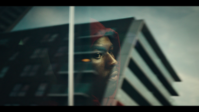 a man looking out of a window at a building