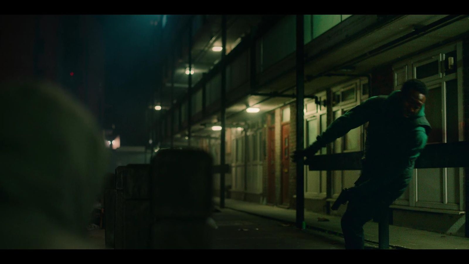 a man standing on a sidewalk next to a building