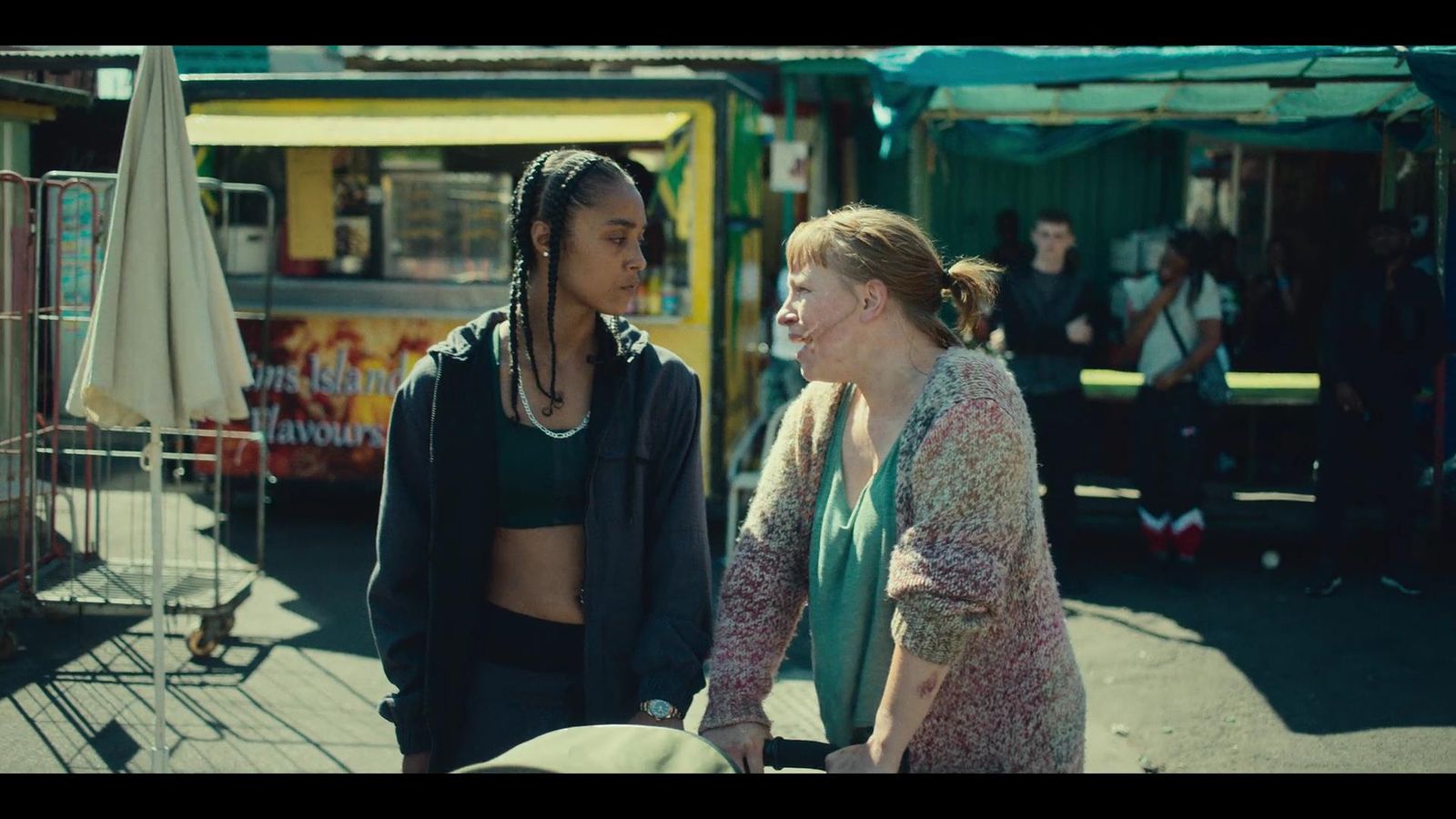 two women standing next to each other on a street