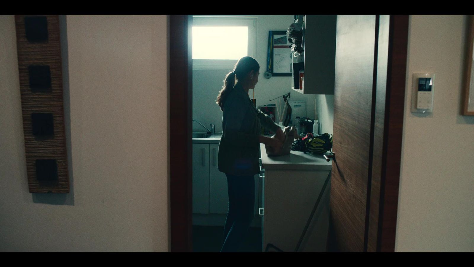 a woman standing in a kitchen next to a sink