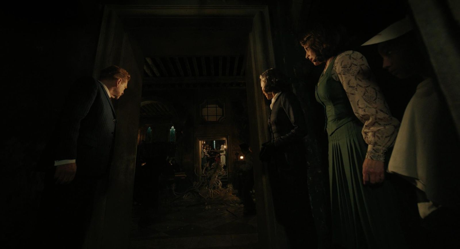 a group of people standing in a dark hallway