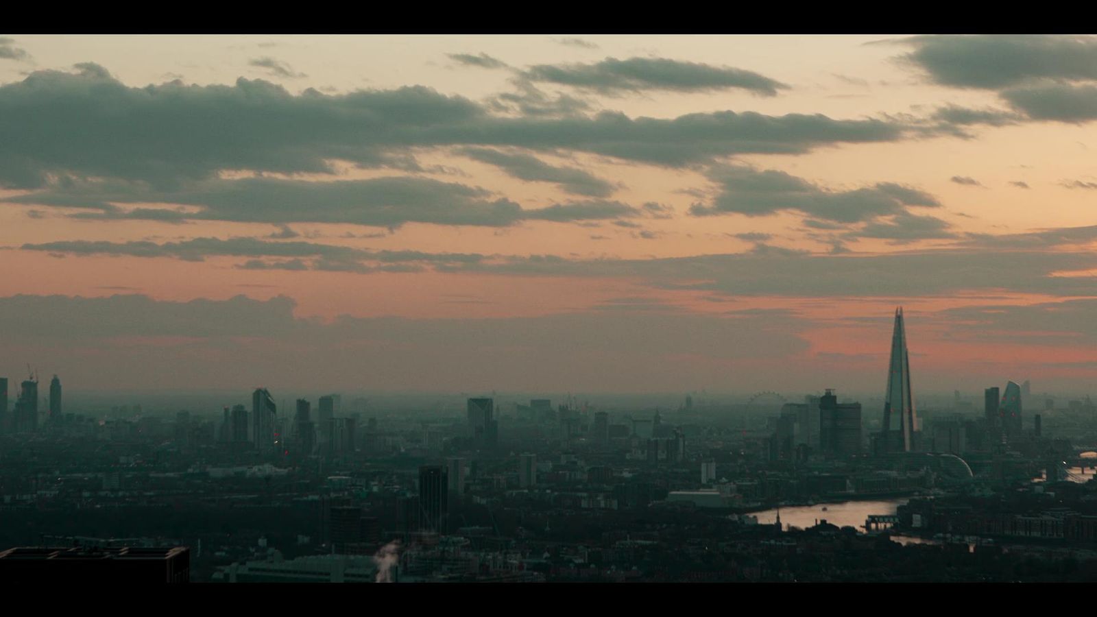 a view of a city at sunset from the top of a building