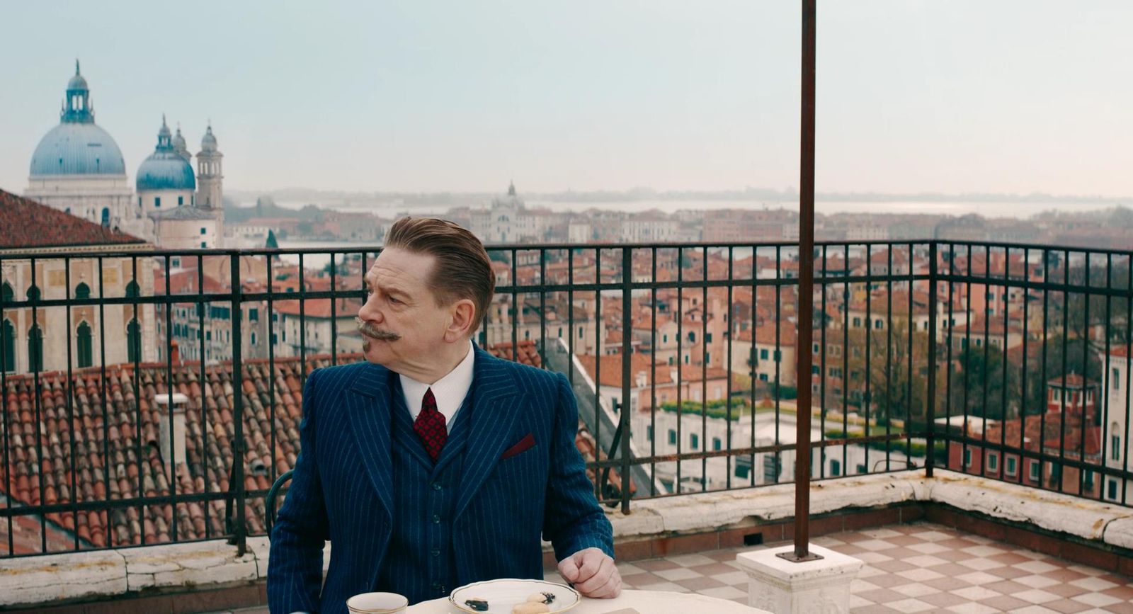 a man in a suit and tie sitting at a table