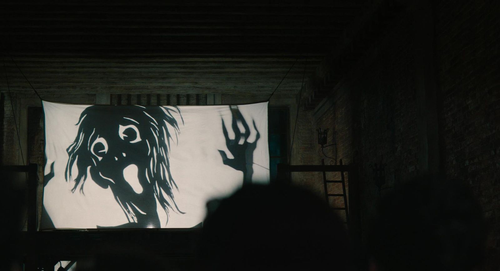 a person standing in front of a large screen