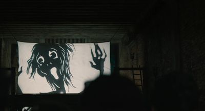 a person standing in front of a large screen