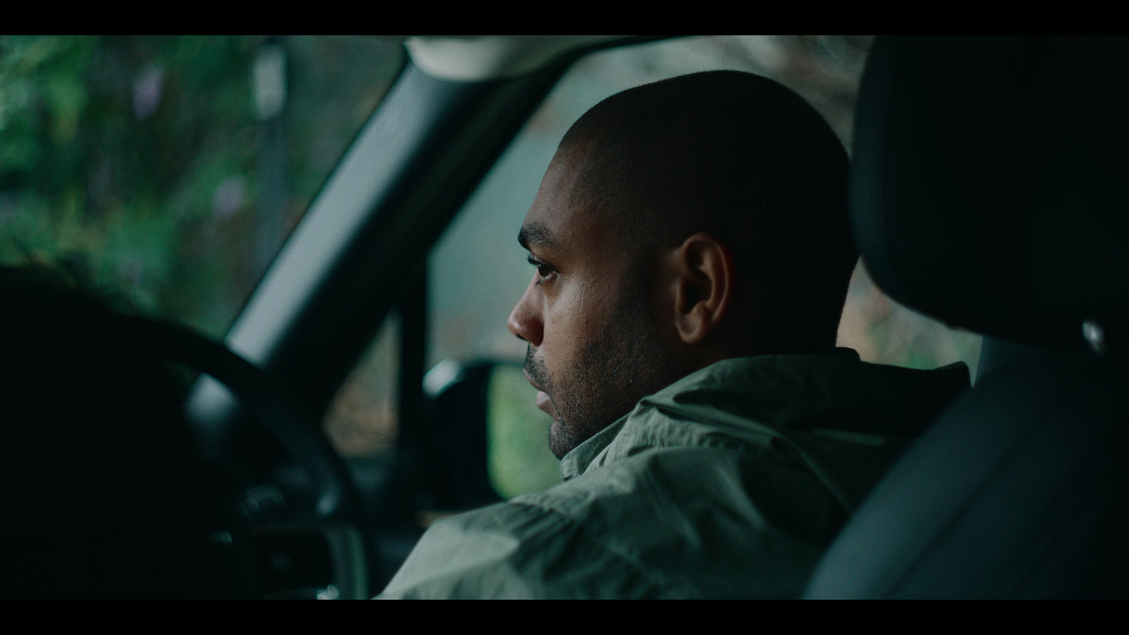 a man sitting in the drivers seat of a car