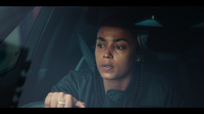 a woman with braids sitting in a car
