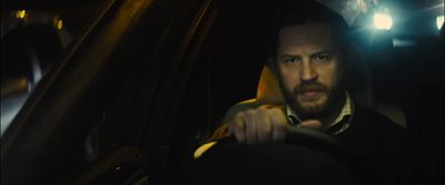 a man driving a car in the dark