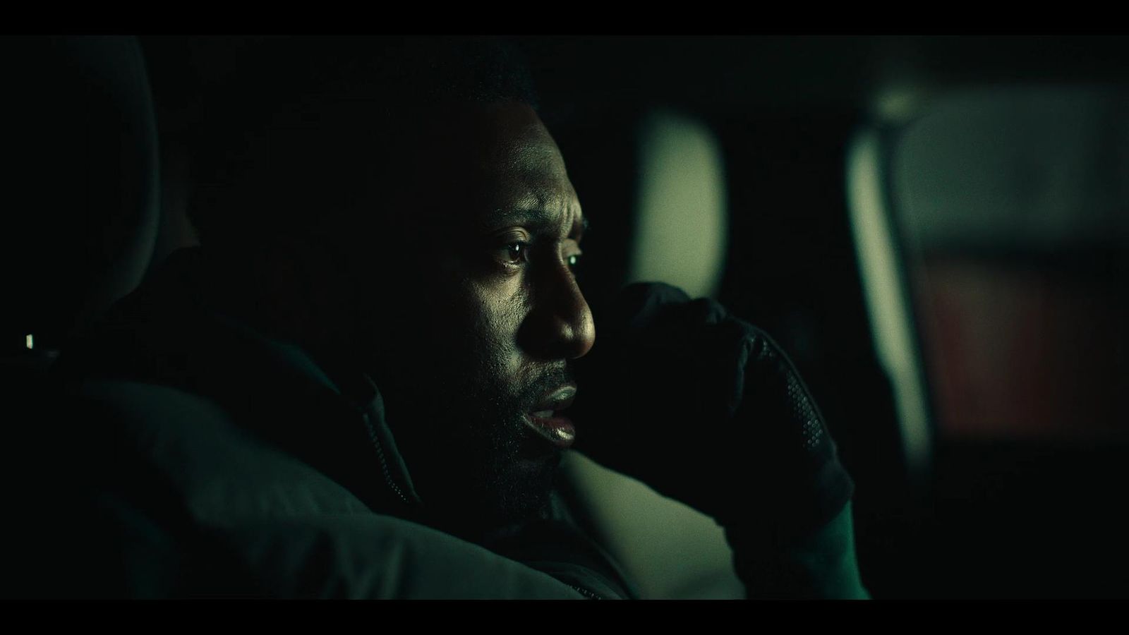 a man sitting in the passenger seat of a car