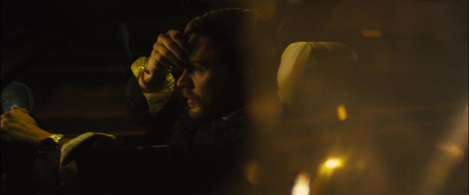 a man sitting in a car holding a banana