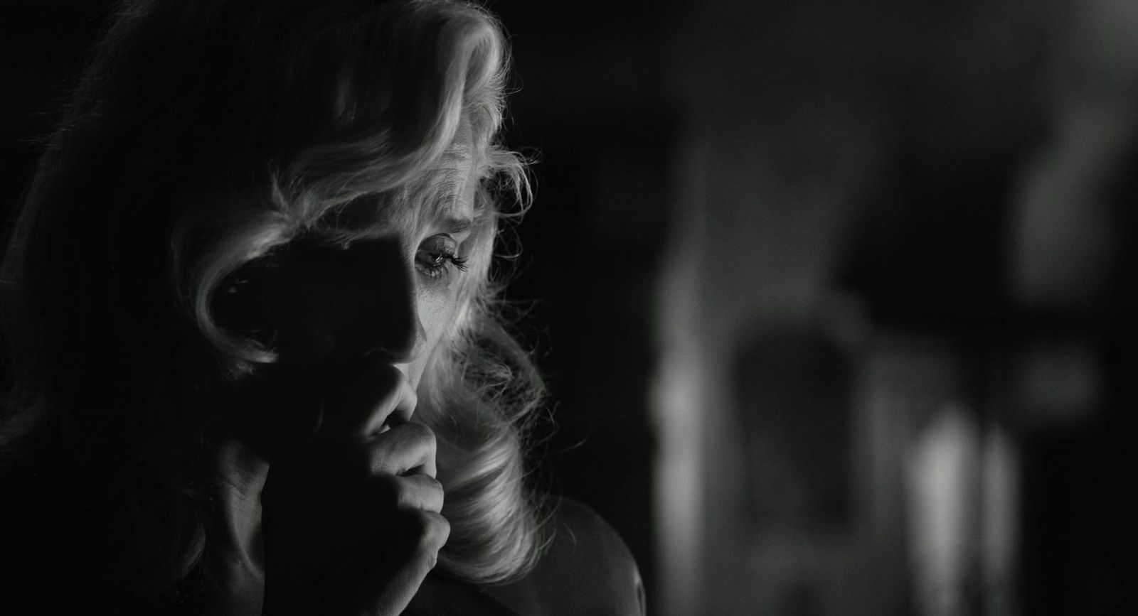 a black and white photo of a woman talking on a cell phone