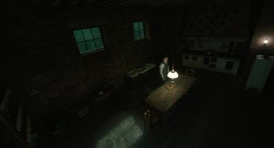 a dark room with a table and a lamp