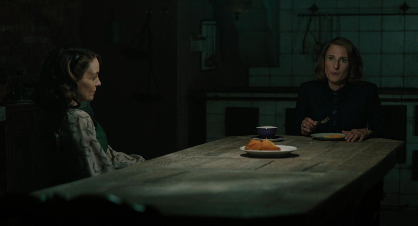 a woman sitting at a table with a plate of food