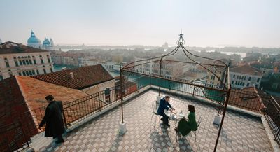 a group of people standing on top of a roof