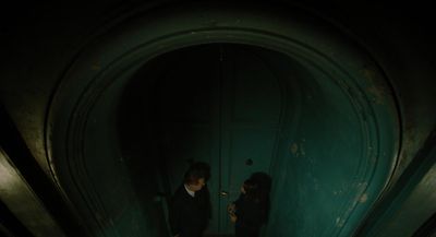 a man and a woman standing in a dark hallway