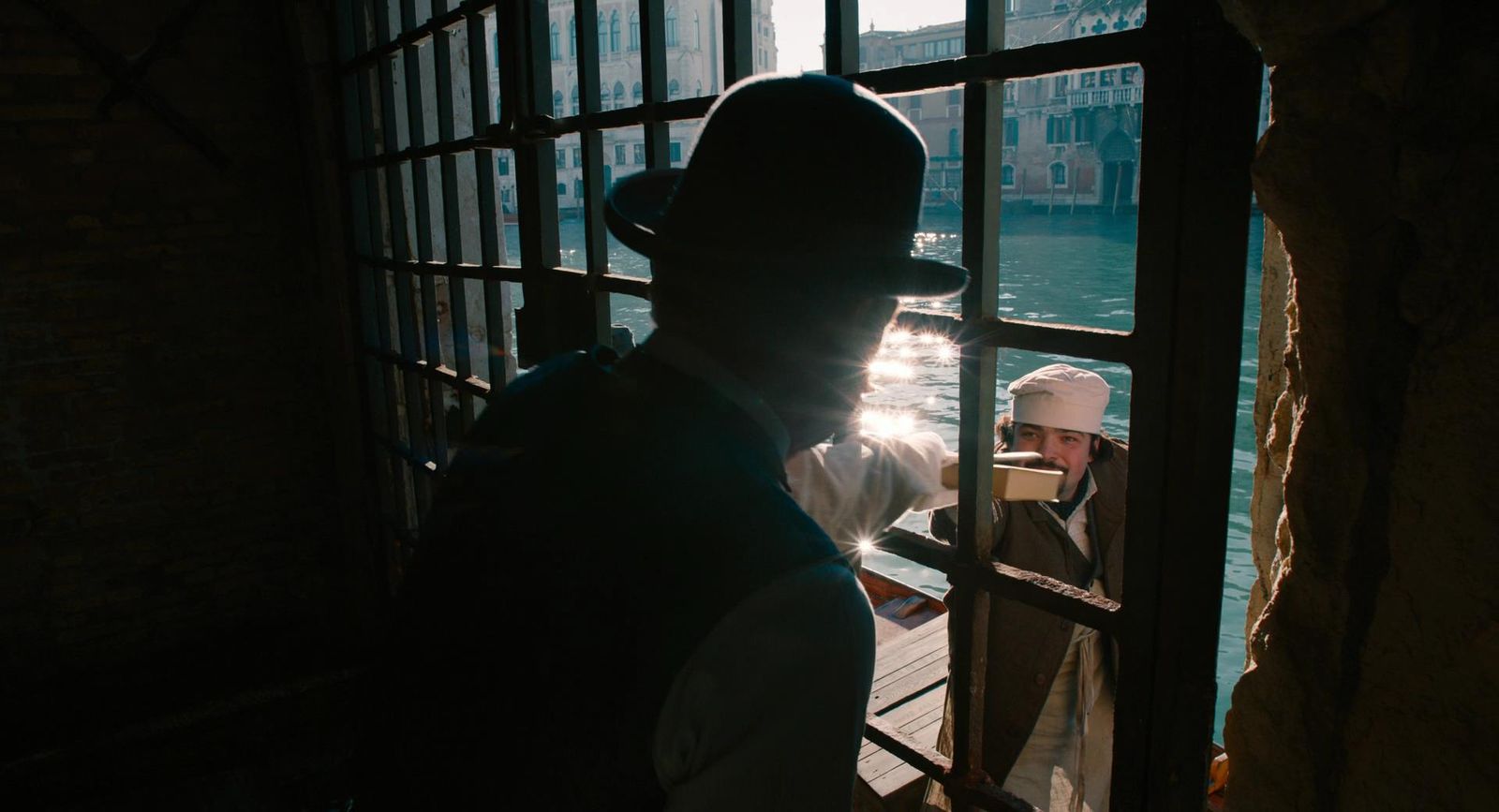 a man standing next to a window in a building