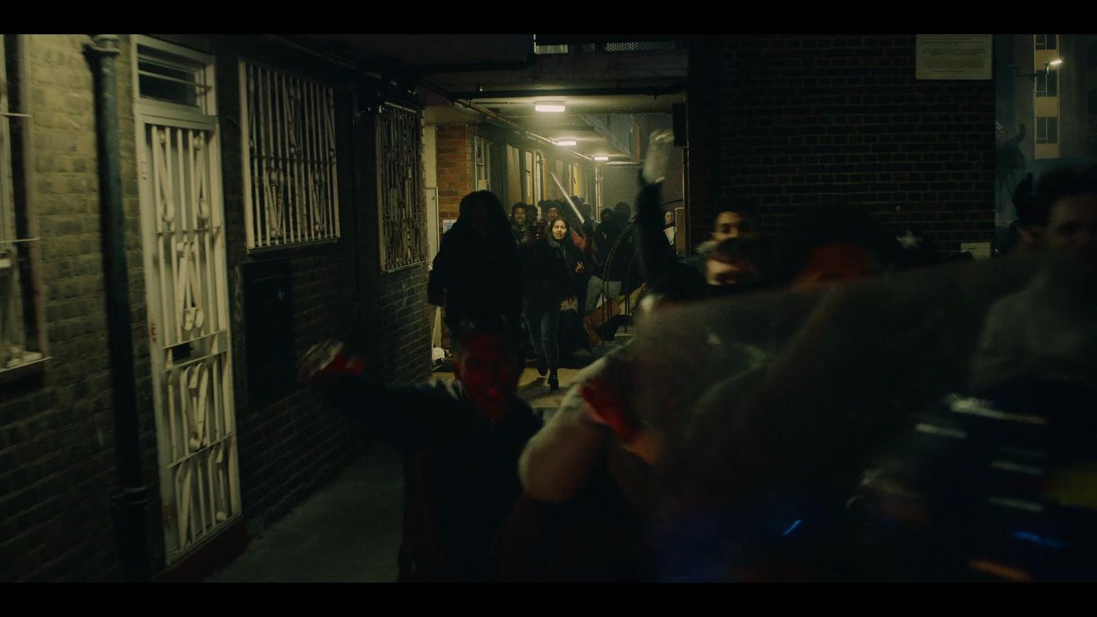 a group of people walking down a dark alley