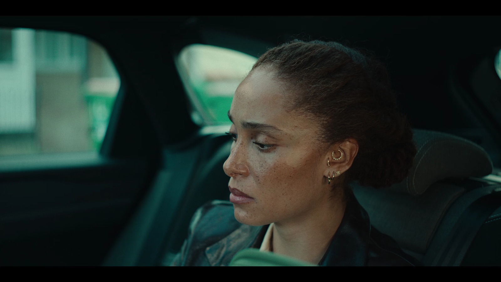 a woman sitting in the back seat of a car