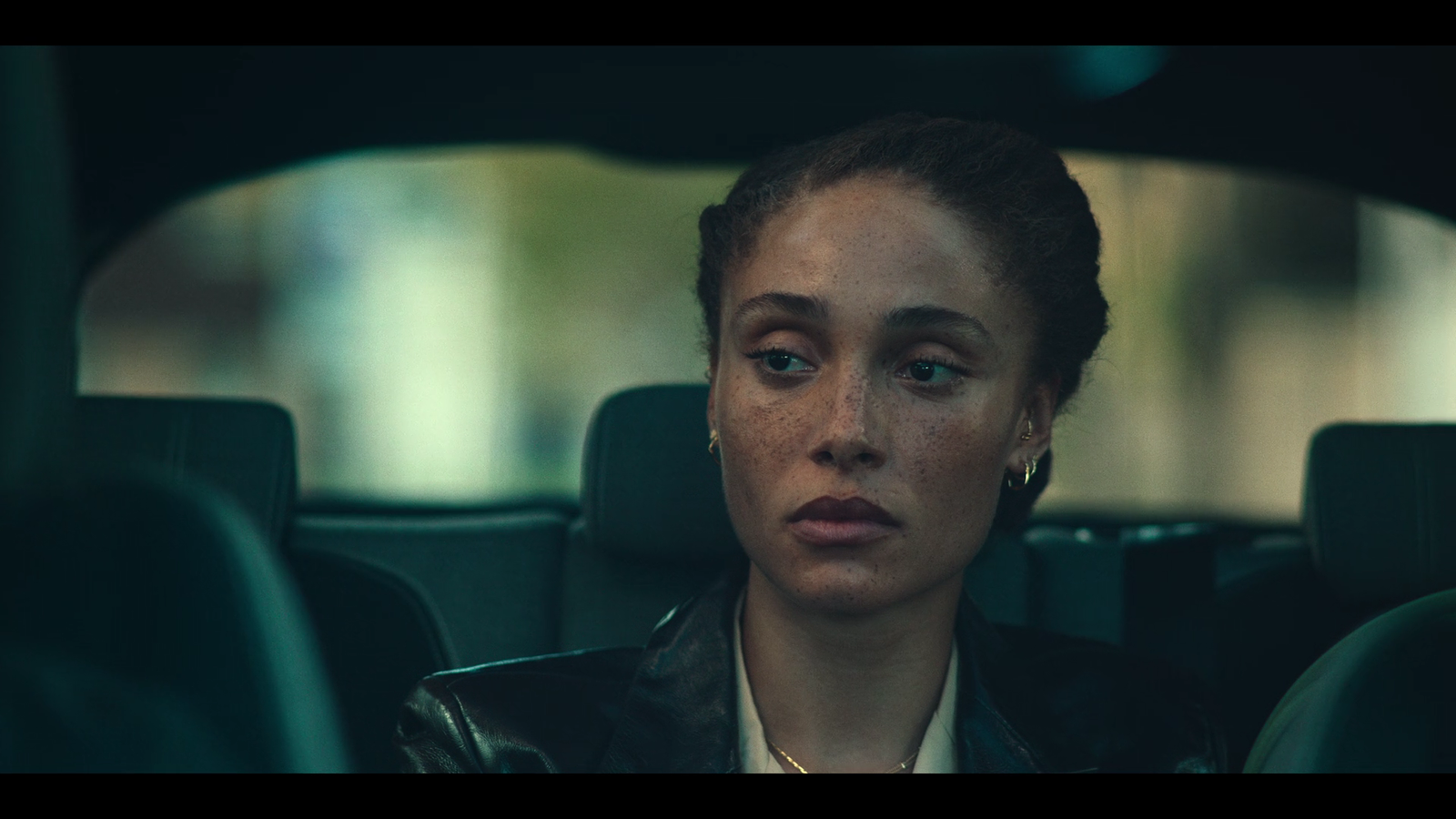 a woman sitting in the back seat of a car