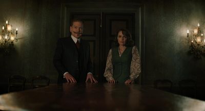 a man and a woman standing in front of a table