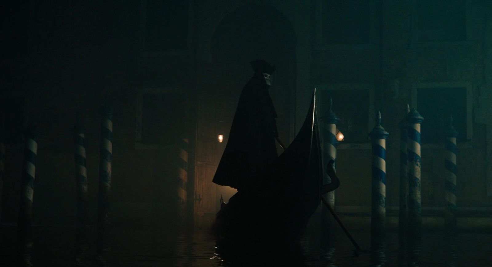 a person in a dark room with a boat in the water