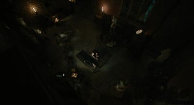 an overhead view of a dark room with people sitting at tables