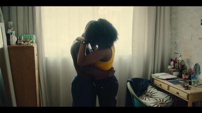 two people hugging each other in a room