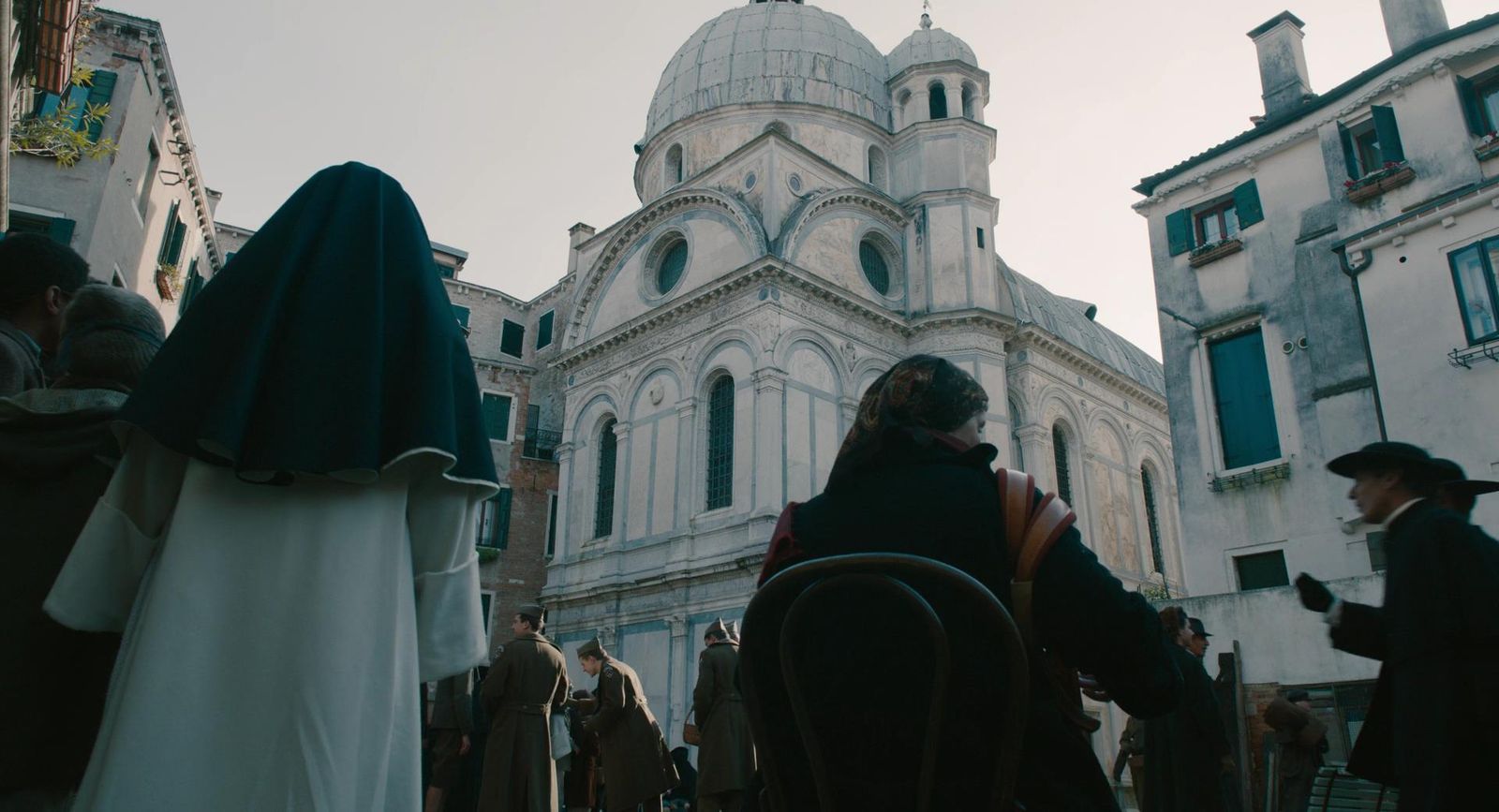 a group of people standing in front of a church