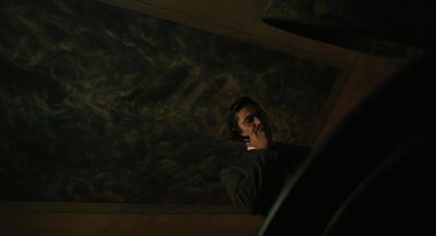 a man talking on a cell phone in a dark room