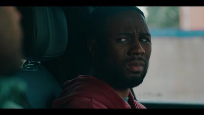 a man sitting in a car looking at the camera