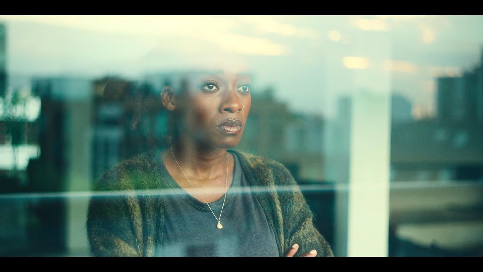 a woman standing in front of a window