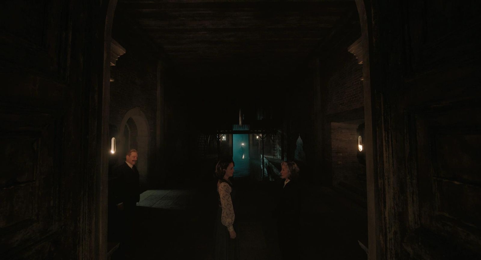 a group of people standing in a dark hallway