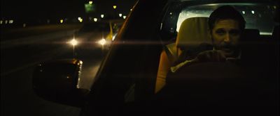 a man sitting in a car at night