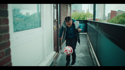 a man in a suit is playing with a soccer ball