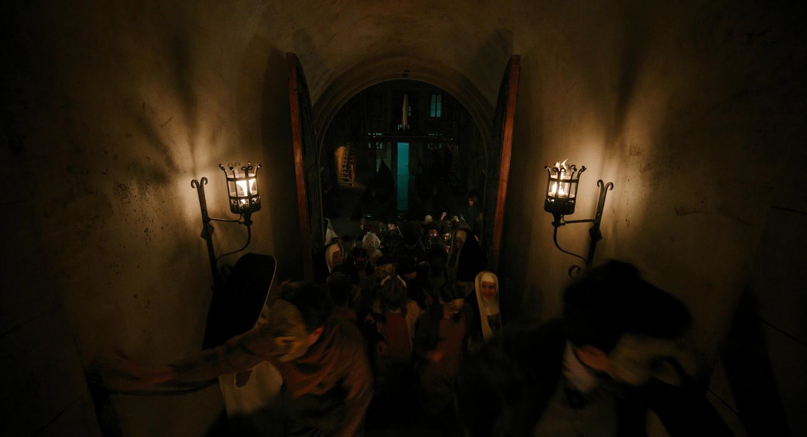 a group of people walking down a dark hallway