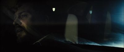 a man driving a car in the dark