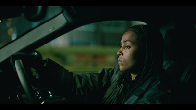 a woman driving a car in the dark