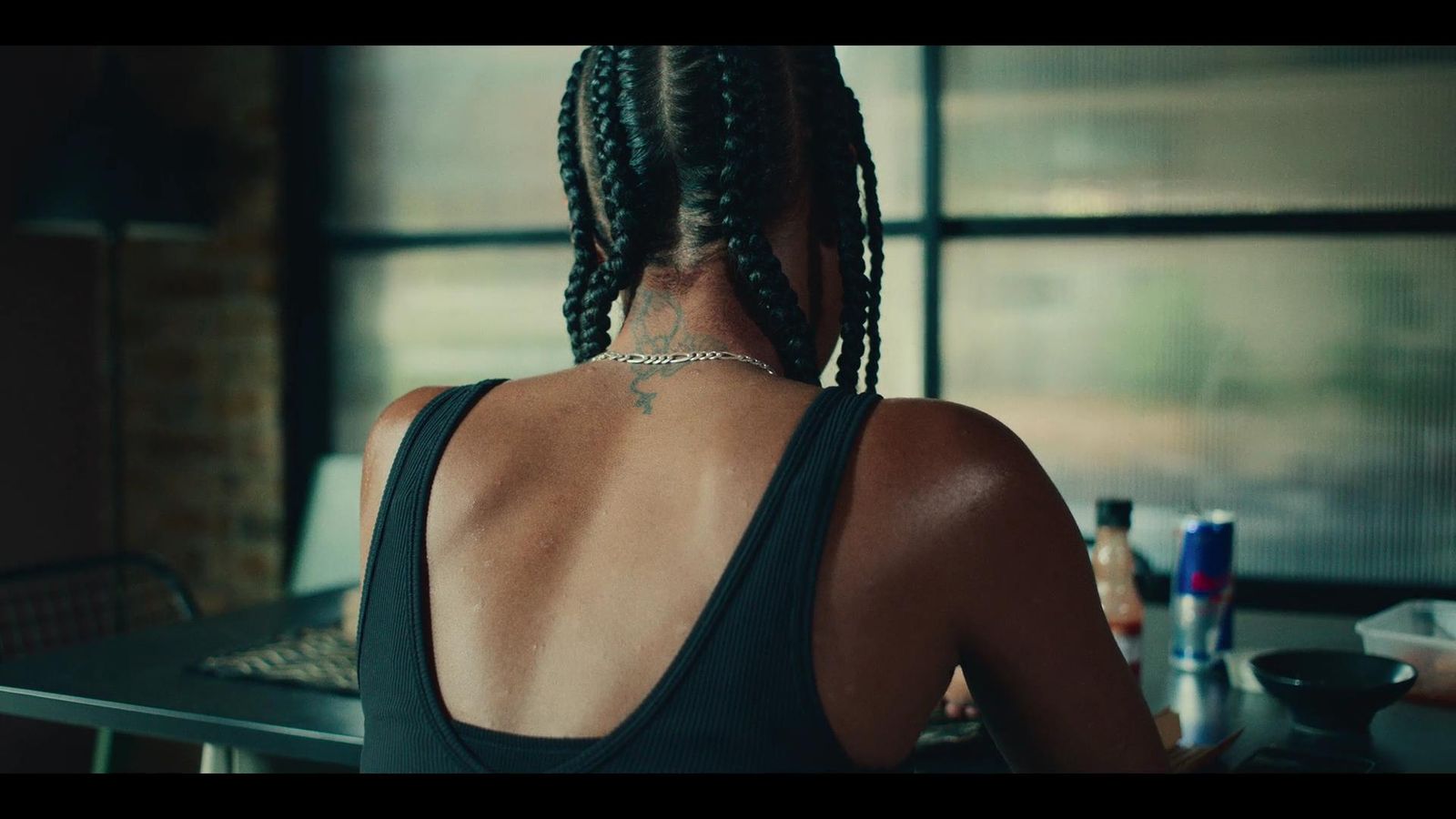 a woman sitting at a table with her back to the camera