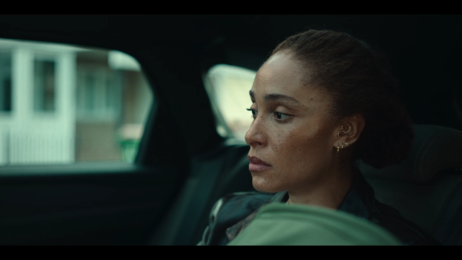 a woman sitting in the back seat of a car