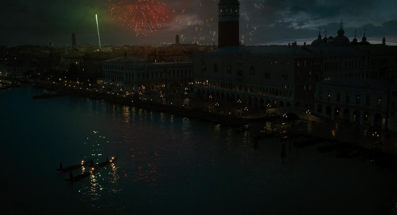 fireworks are lit up in the night sky over a river