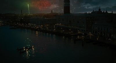 fireworks are lit up in the night sky over a river