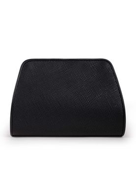 a black purse sitting on top of a white surface